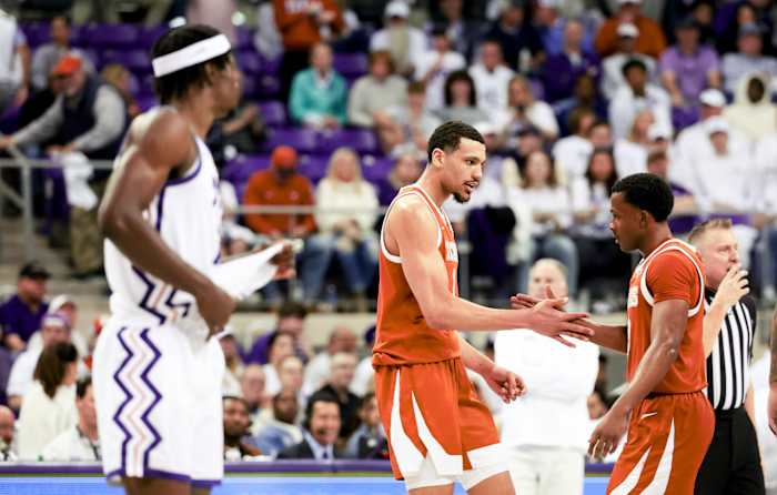 Feb 3, 2024; Fort Worth, Texas, USA; Texas Longhorns guard Max Abmas (3) celebrates with Texas Longhorns forward Dylan Disu (1) in front of TCU Horned Frogs forward Emanuel Miller (2) during the second half at Ed and Rae Schollmaier Arena. Mandatory Credit: Kevin Jairaj-USA TODAY Sports